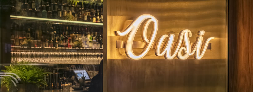 OASI restaurant bar in Shenzhen with illuminated entrance sign and bar interior