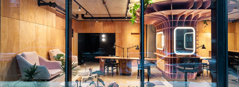 Le Hideout beauty salon in Montreal with pink sculptural structure and wood panelling