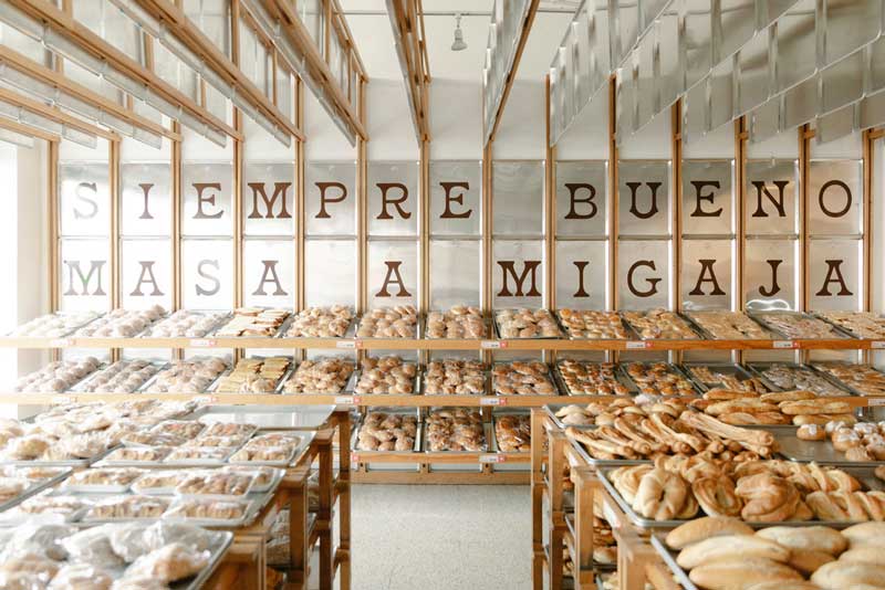 Mi Pan Bakery in Mexico City designed by Concentrico with metallic trays and warm wood surfaces