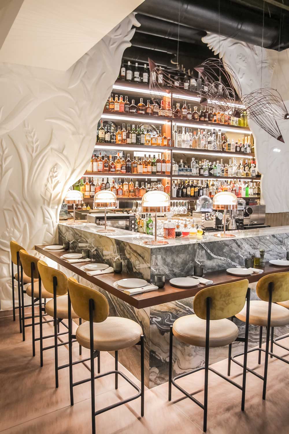 Interior of Bobo bar bistrot with yellow seating and Mediterranean-inspired color palette