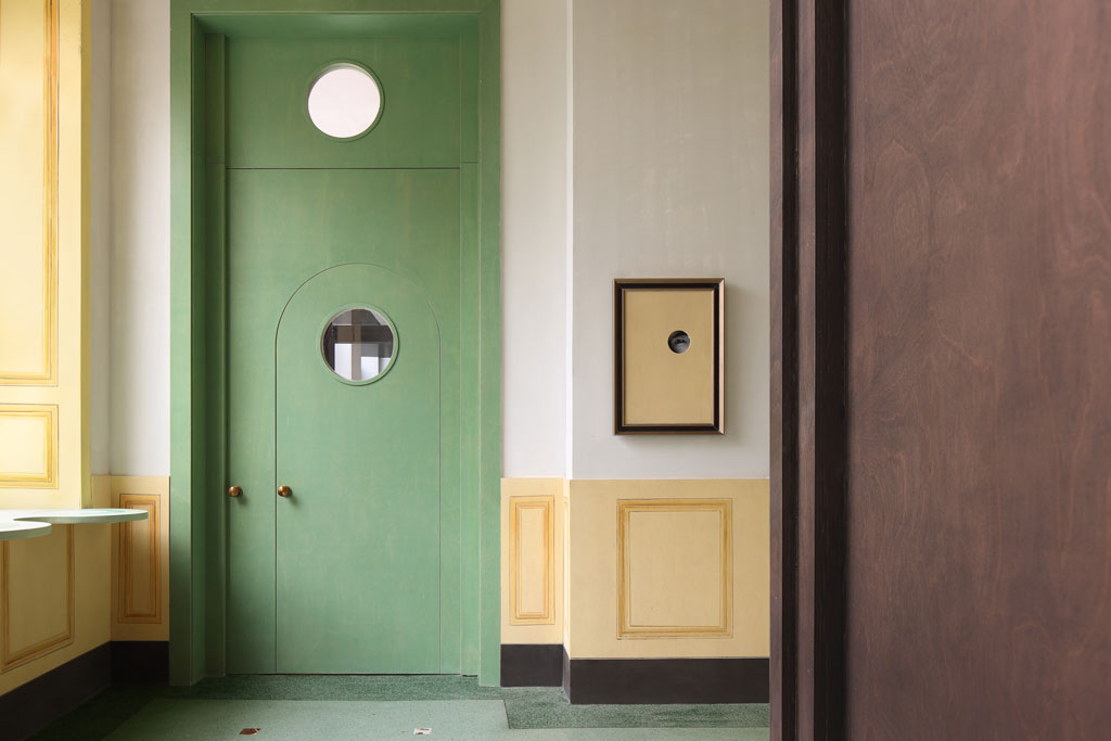 Pistachio-colored entrance doors contrasting with red brick facade in Bitter Sweetie dessert shop Tianjin