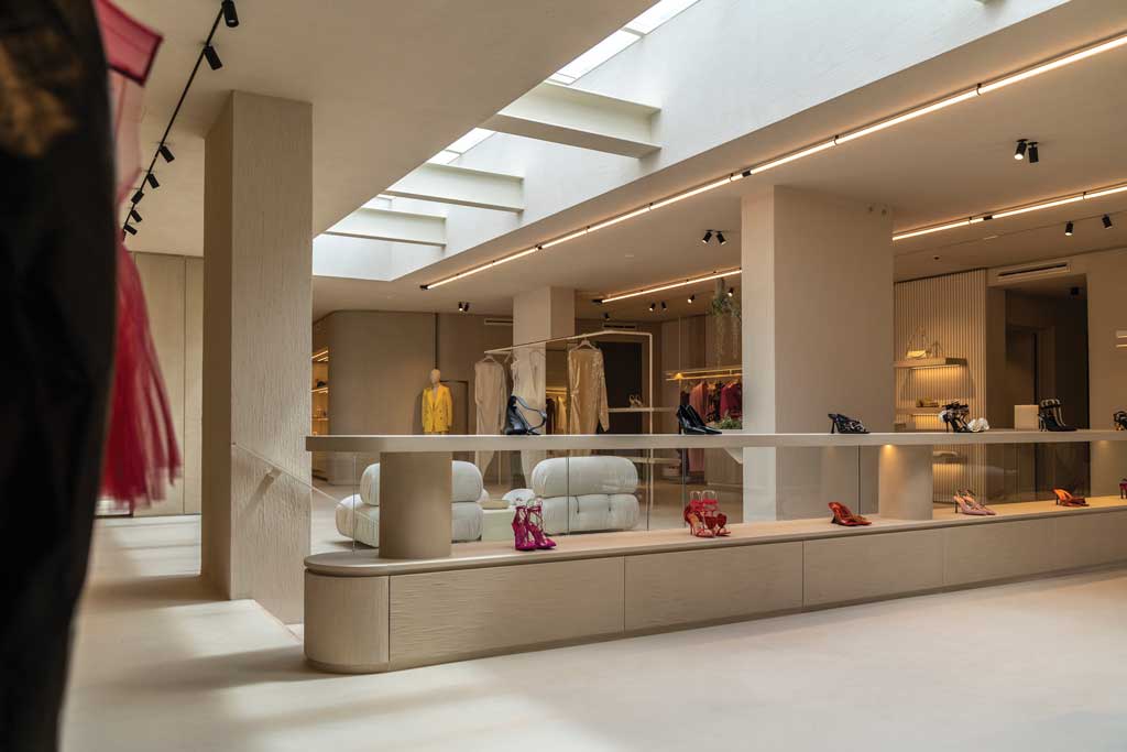 DIVINCENZO boutique interiors with iron and travertine staircase and glass balustrades