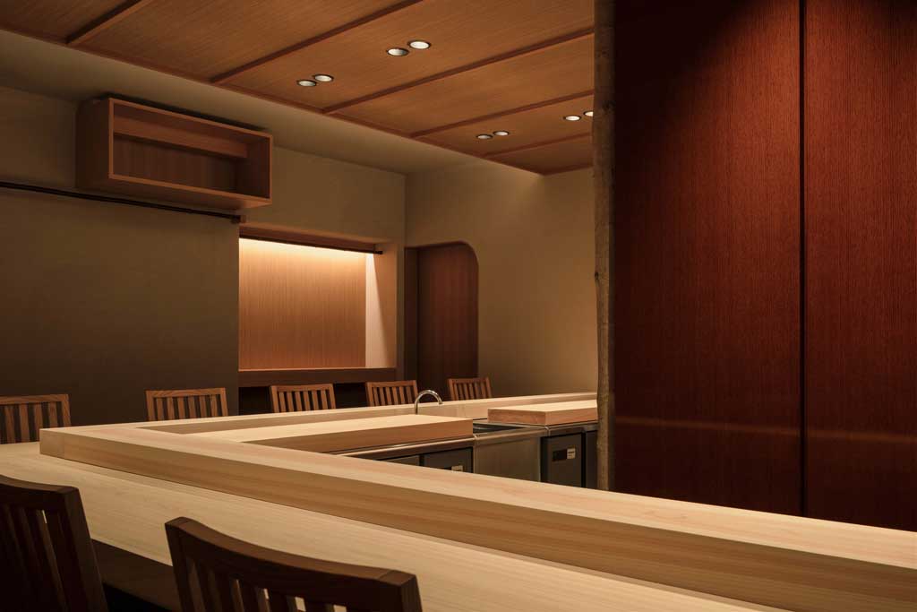 Dining area at Sushidokoro Yamada with intimate seating layout and warm materials