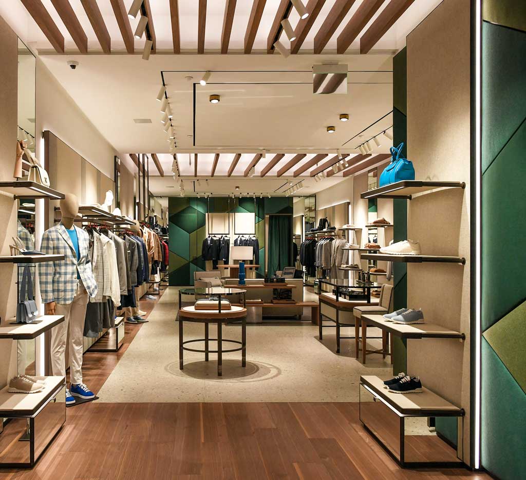 Kiton flagship store Miami Bal Harbour Shops interior with custom furniture and natural light