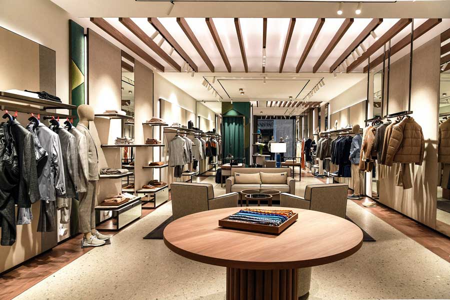Kiton Miami boutique interior with clothing display and natural materials
