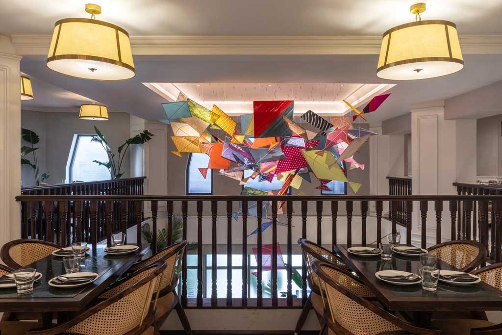 Restaurant space with wood finishes at Bombay Brasserie