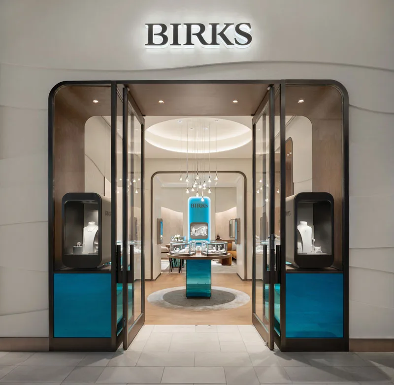 Modern retail space at Royalmount showcasing warm tones and innovative design elements that reflect Birks' rich heritage.
