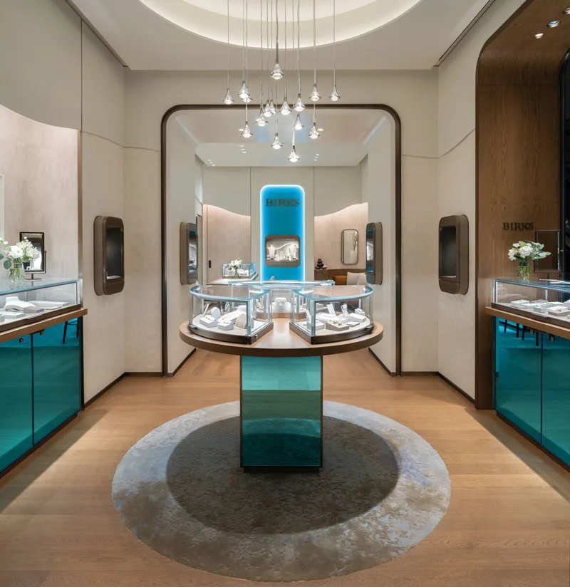 Interior view of Birks' concept store featuring blue accents, soft curves, and state-of-the-art lighting.