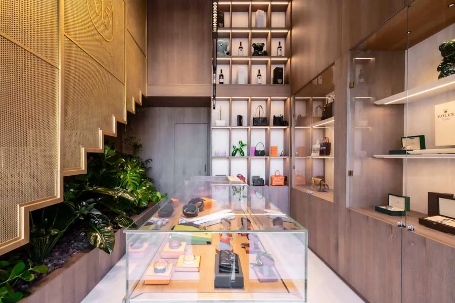 Interior of Boutique M5 Original Luxury in Palermo: custom wooden displays, bespoke showcases, golden staircase and green elements