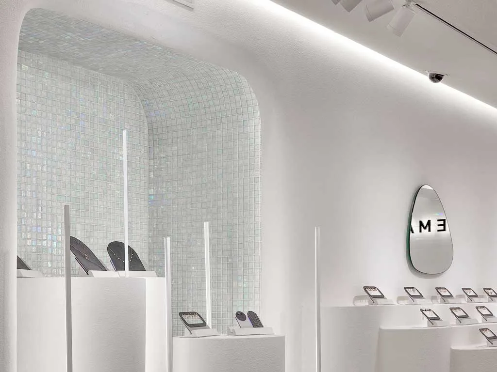 Detail of the Aremar Showroom with iridescent mosaic and jewelry displays: an example of jewelry showroom design with scenographic elements.