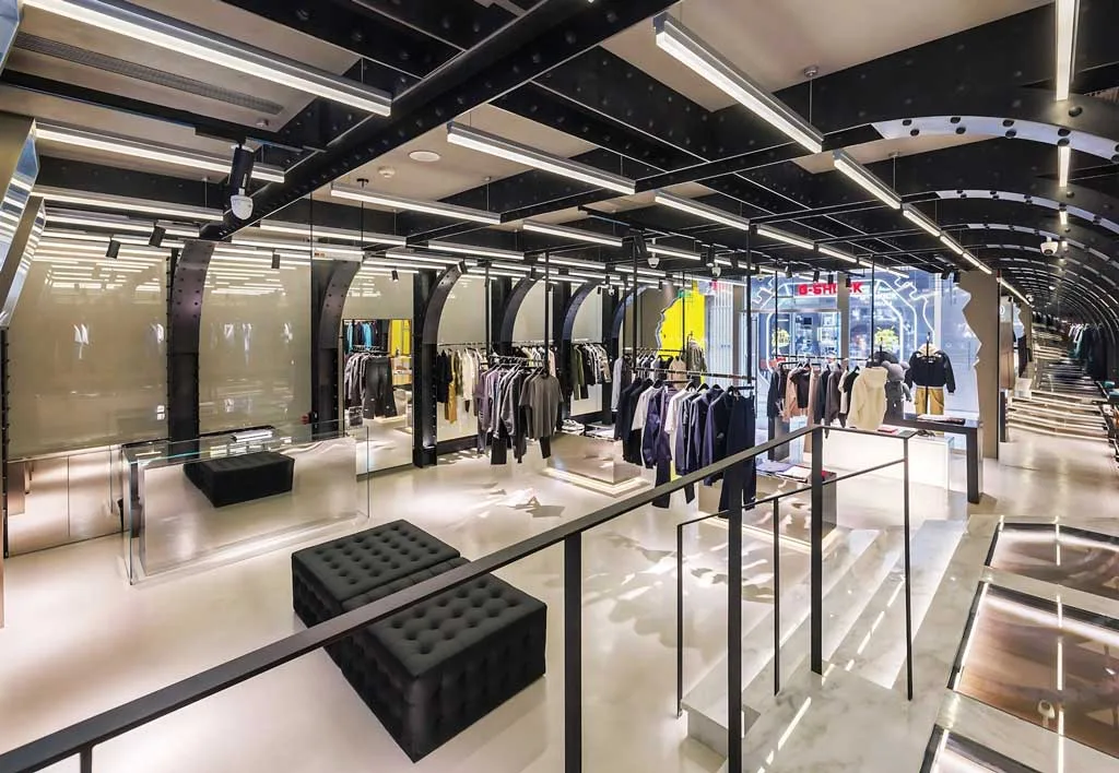 Interior of Roarguns' futuristic concept store in Beijing, featuring a black metal structure, LED lighting and minimalist displays