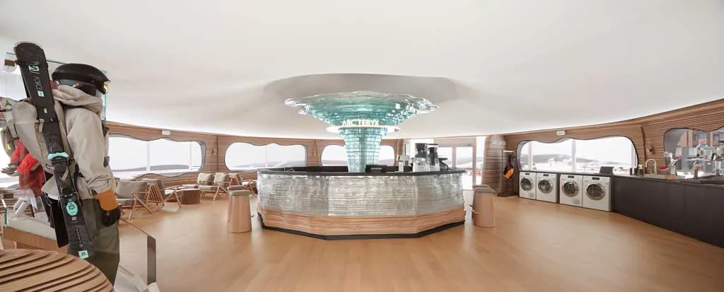 Interior of the ReBIRD™ Service Center by ARC'TERYX with central bar and ice sculpture"