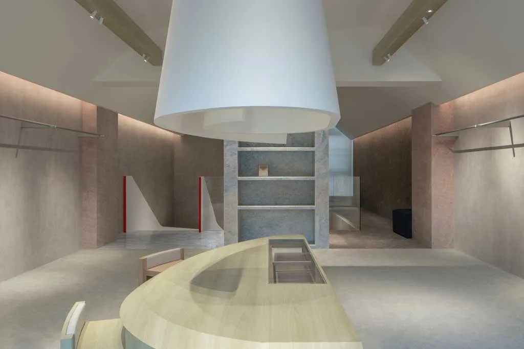 Central area of the AVVENN concept store in Shanghai with a curved wooden counter, stone shelving and a large cone-shaped suspended element