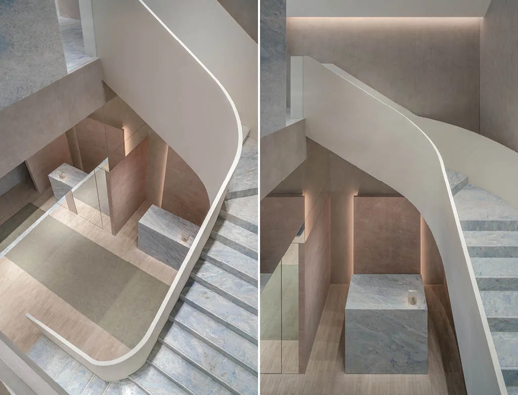 Sculptural stone staircase with curved balustrade in the AVVENN concept store in Shanghai, with a top view of the marble-clad display area