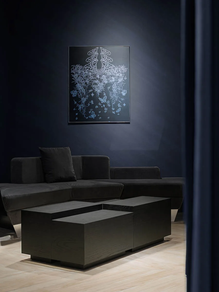 VIP lounge area inside the MITHRIDATE boutique in Guangzhou, featuring dark seating, geometric tables, and blue wall art – designed by SLT Design