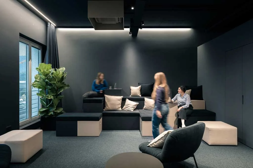 Area relax con gradonata imbottita nella sede ADDITIVE a Bolzano, progettata da NOA per promuovere socialità e benessere nei luoghi di lavoro