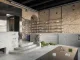 Storage, il negozio streetwear maschile del concept store a Kiev, con pareti in mattoni originali, arredi in cemento grezzo e dettagli metallici.
