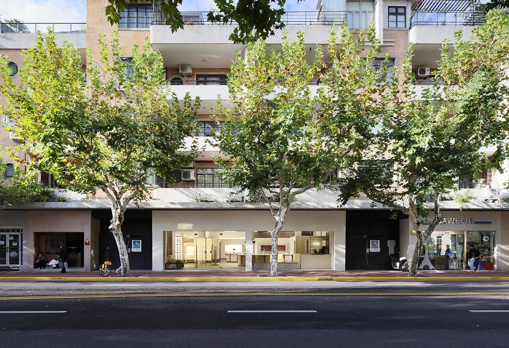 Facciata della RERY Fashion Lifestyle Gallery a Shanghai, integrata nel contesto urbano di Huaihai Road con ampie vetrine e alberature preesistenti