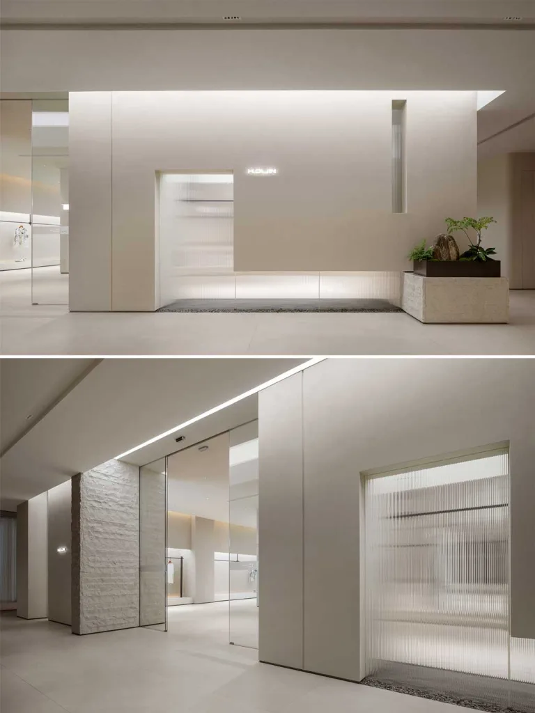 Reception in pietra naturale presso lo showroom moda a Foshan progettato da LubanEra Design – minimalismo materico e luce integrata.