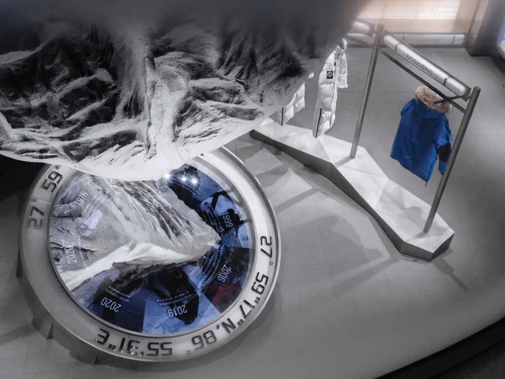 Detail of the setup featuring a topographic reproduction of Everest and engraved coordinates – immersive concept of the Bosideng flagship store in Beijing.