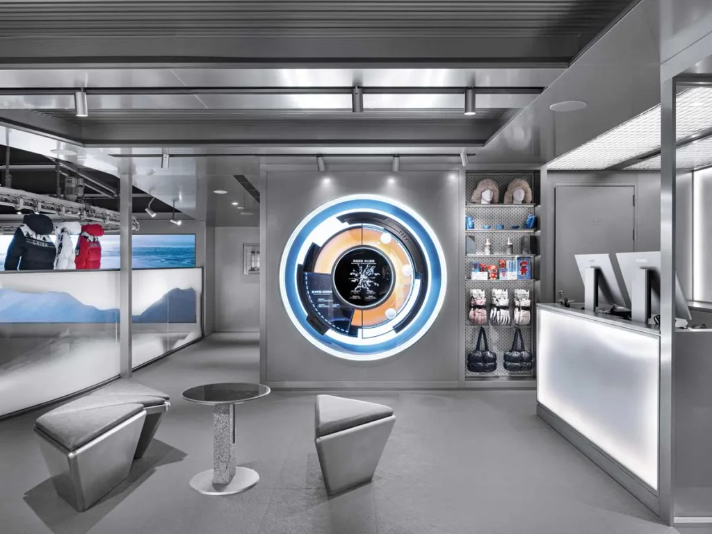 Checkout area of the Bosideng flagship store in Sanlitun featuring steel furnishings and a circular interactive screen – futuristic and functional design.