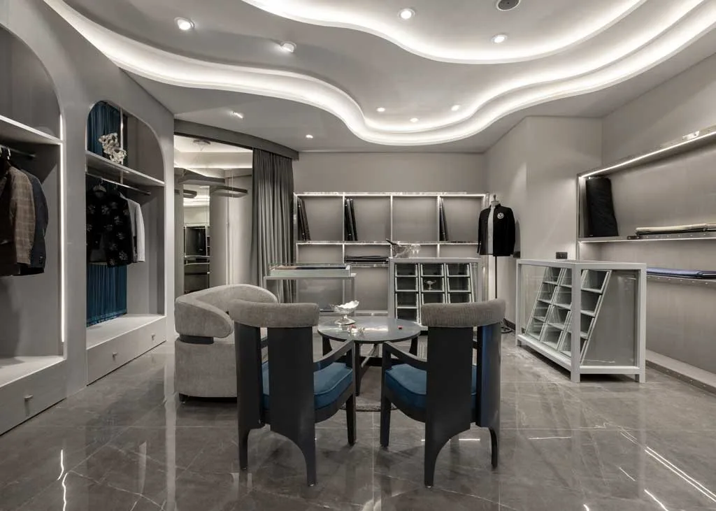 Interior view of the Mukund Taneja Boutique in Amritsar with backlit wavy ceiling, tailored furnishings, and lounge seating area.