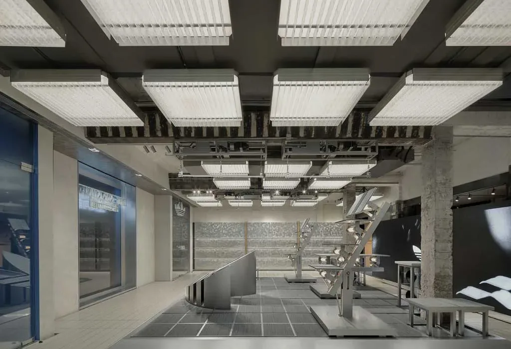 Interni del flagship store Adidas Originals a Shanghai con espositori metallici e illuminazione a soffitto modulare