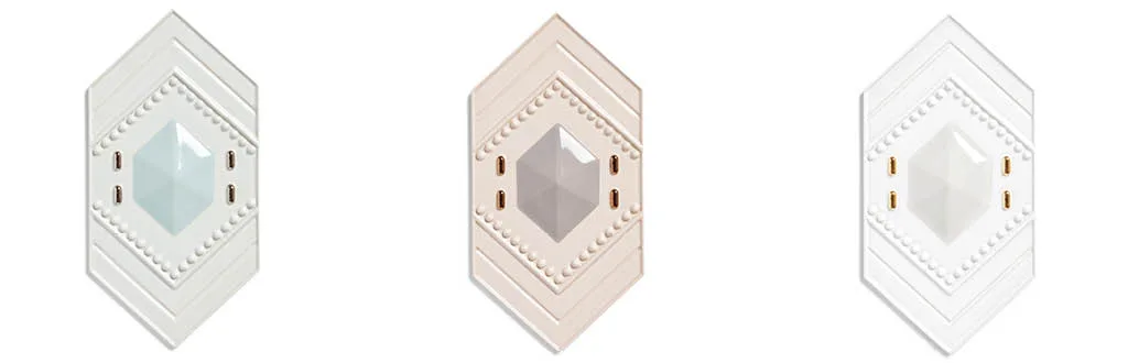 Piastrelle Celestia della collezione Dornette 2025 in ceramica artigianale, forma esagonale con piramide centrale e sfere decorative, varianti colore neutre