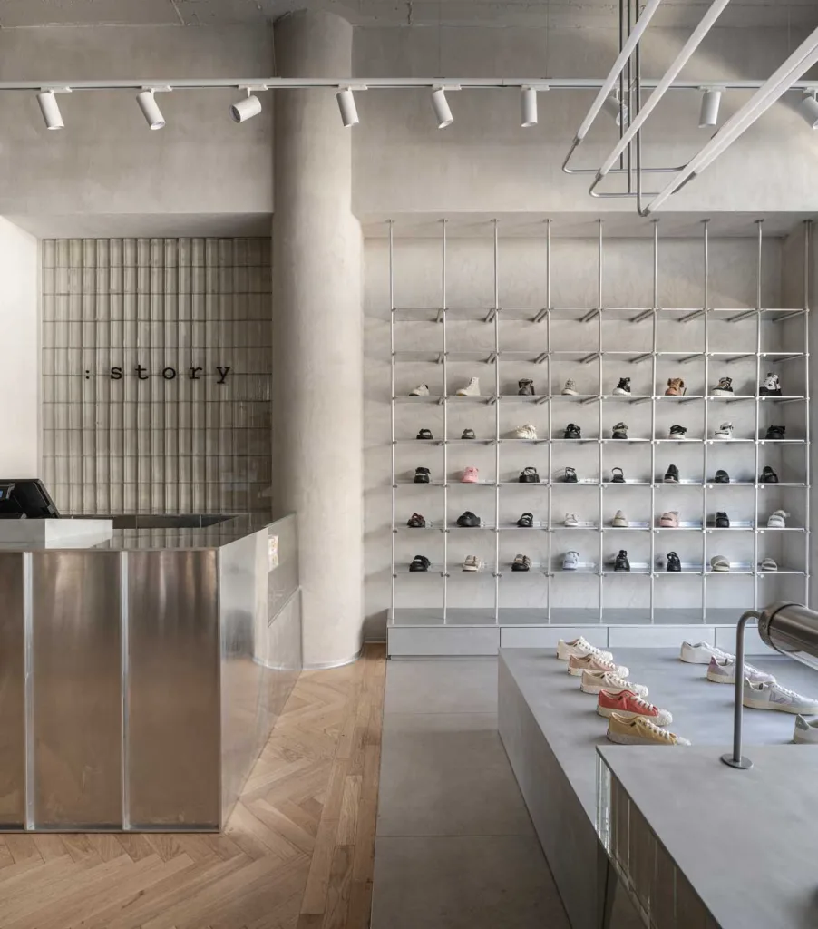 Cash desk in steel and display wall of the :STORY concept store in Jerusalem, featuring organized shelving and minimalist design by Studio ON.