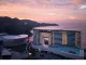 Vista esterna del MGM Shenzhen progettato da CCD, hotel di lusso fronte mare con architettura trapezoidale e facciata vetrata al tramonto