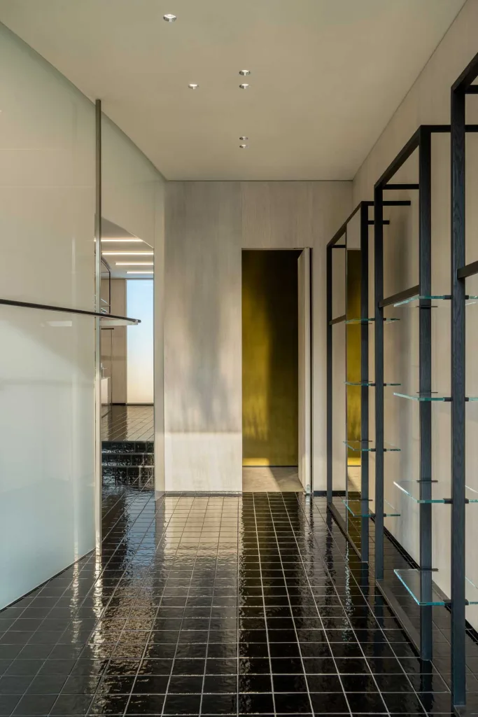 Dettaglio dell’area espositiva del concept store 7+ Select Shop – Glimmering Bay a Zhengzhou con scaffalature in vetro e metallo progettato da say architects