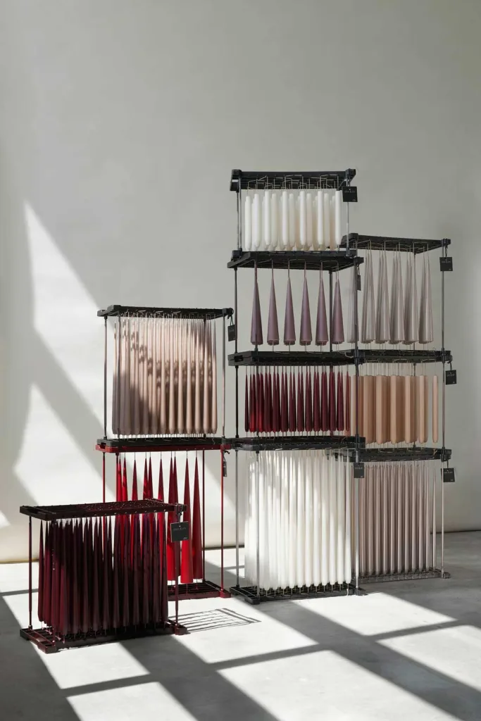 installazione di candele colorate sospese su strutture metalliche modulari, esempio di artigianato contemporaneo presentato a Milano Home 2026