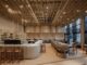 Interni della panetteria di design Krume Bäcker a Panama, con bancone in terra compattata, arredi in legno recuperato e soffitto a listelli. Interior view of Krume Bäcker design bakery in Panama, featuring a rammed earth counter, reclaimed wood furniture, and slatted ceiling structure.