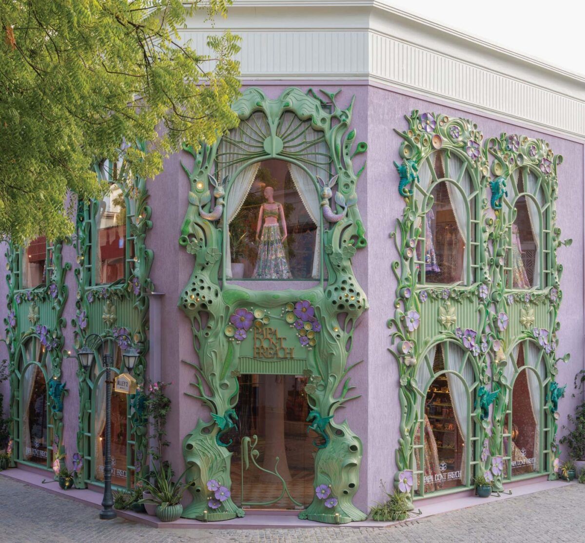 Papa Don’t Preach flagship store facade in Delhi featuring sculptural green frames, floral motifs and nature-inspired details on lavender surfaces