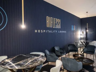 Hospitality Lounge RIFLESSI con arredi su misura in tonalità blu e dettagli oro