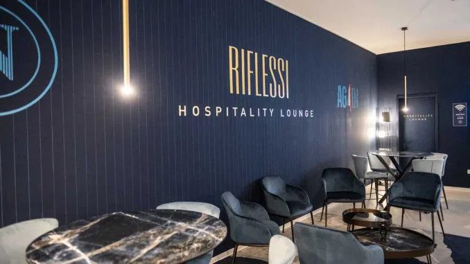 Hospitality Lounge RIFLESSI con arredi su misura in tonalità blu e dettagli oro