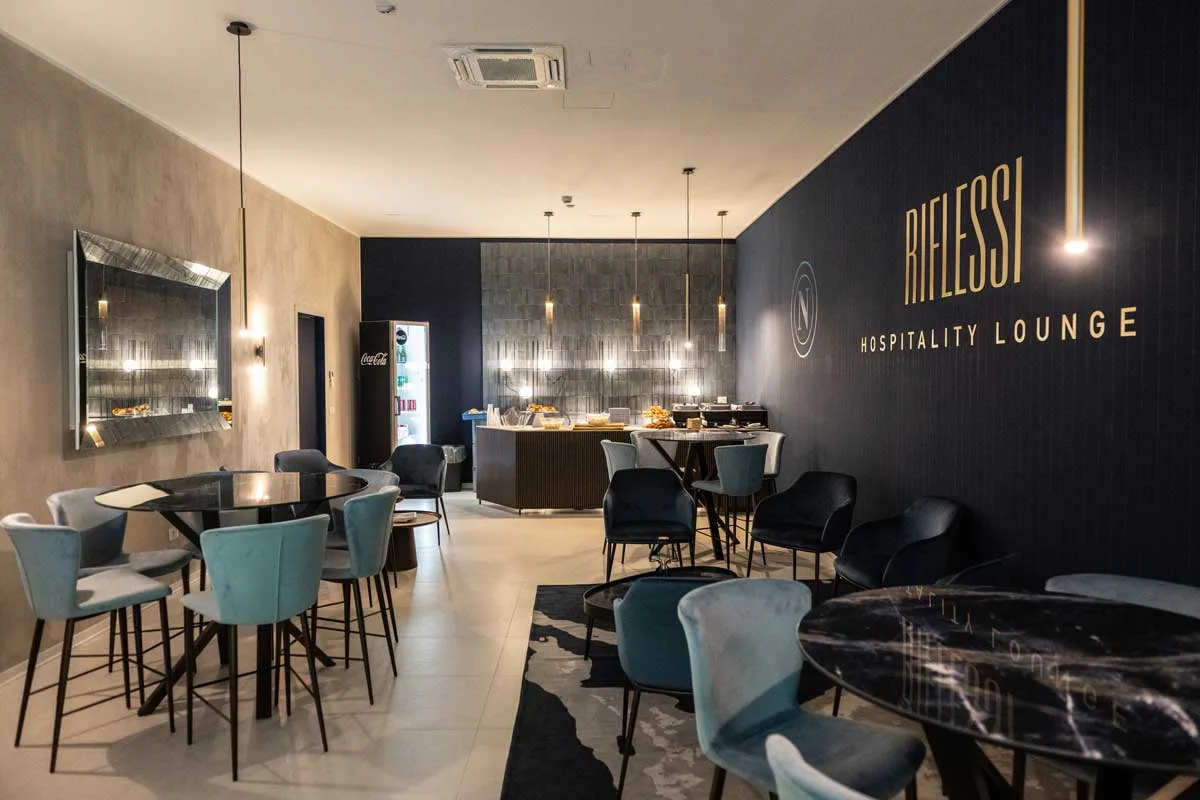 arredi su misura RIFLESSI con bancone bar e sedute in tonalità blu nella Hospitality Lounge dello stadio Maradona a Napoli