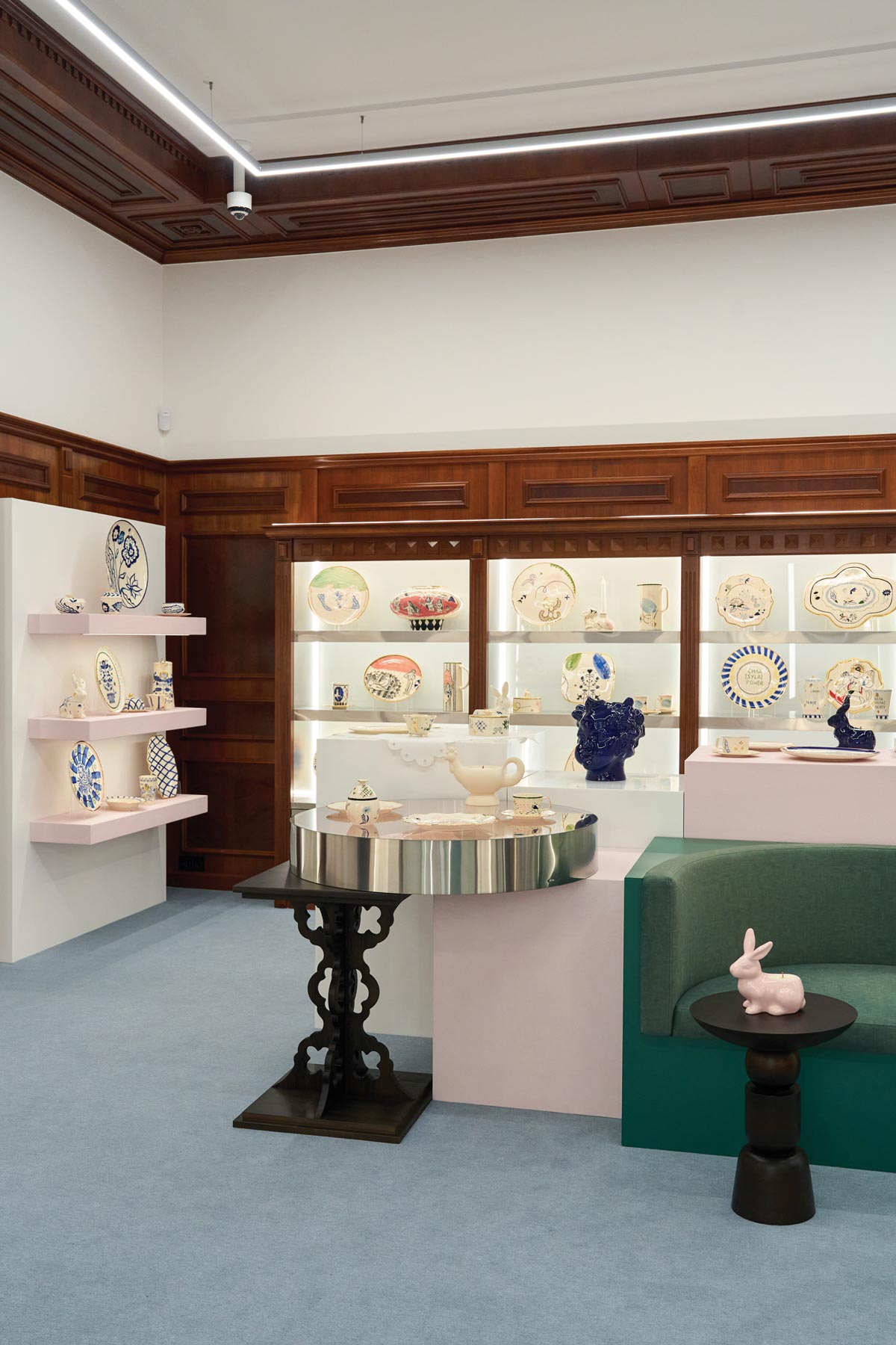 Exhibition space of the GUNIA Project flagship store in Kyiv featuring original wooden boiserie and display cases for ceramic collections