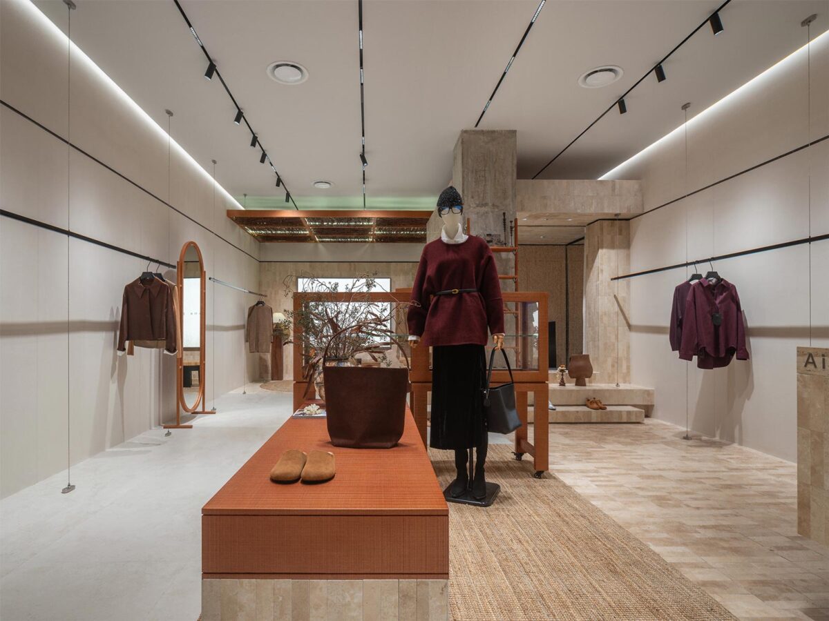 AimeeHe Studio retail store in Shenzhen, central display area with island layout, natural materials, linear ceiling lighting and minimalist fashion setup