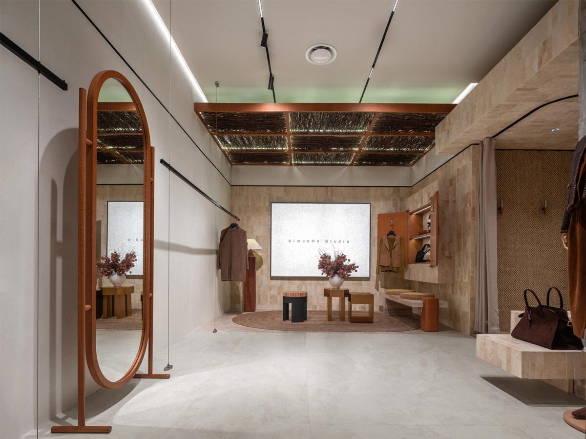 AimeeHe Studio retail store in Shenzhen, interior space with light walls, wooden furnishings, full-height mirror and a soft atmosphere shaped by light and materials