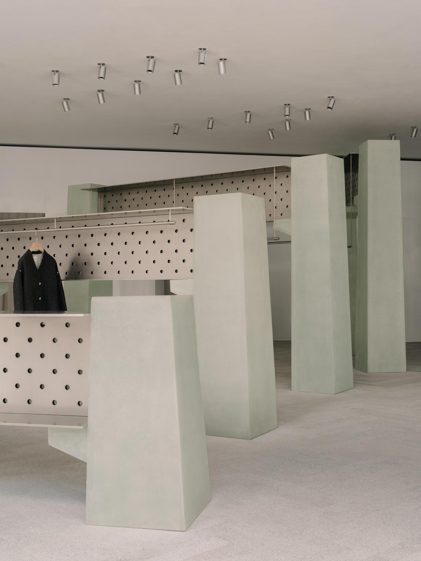 Sculptural display structures and perforated metal panels inside the sage flagship store in Shenzhen, Urban Dockyard concept