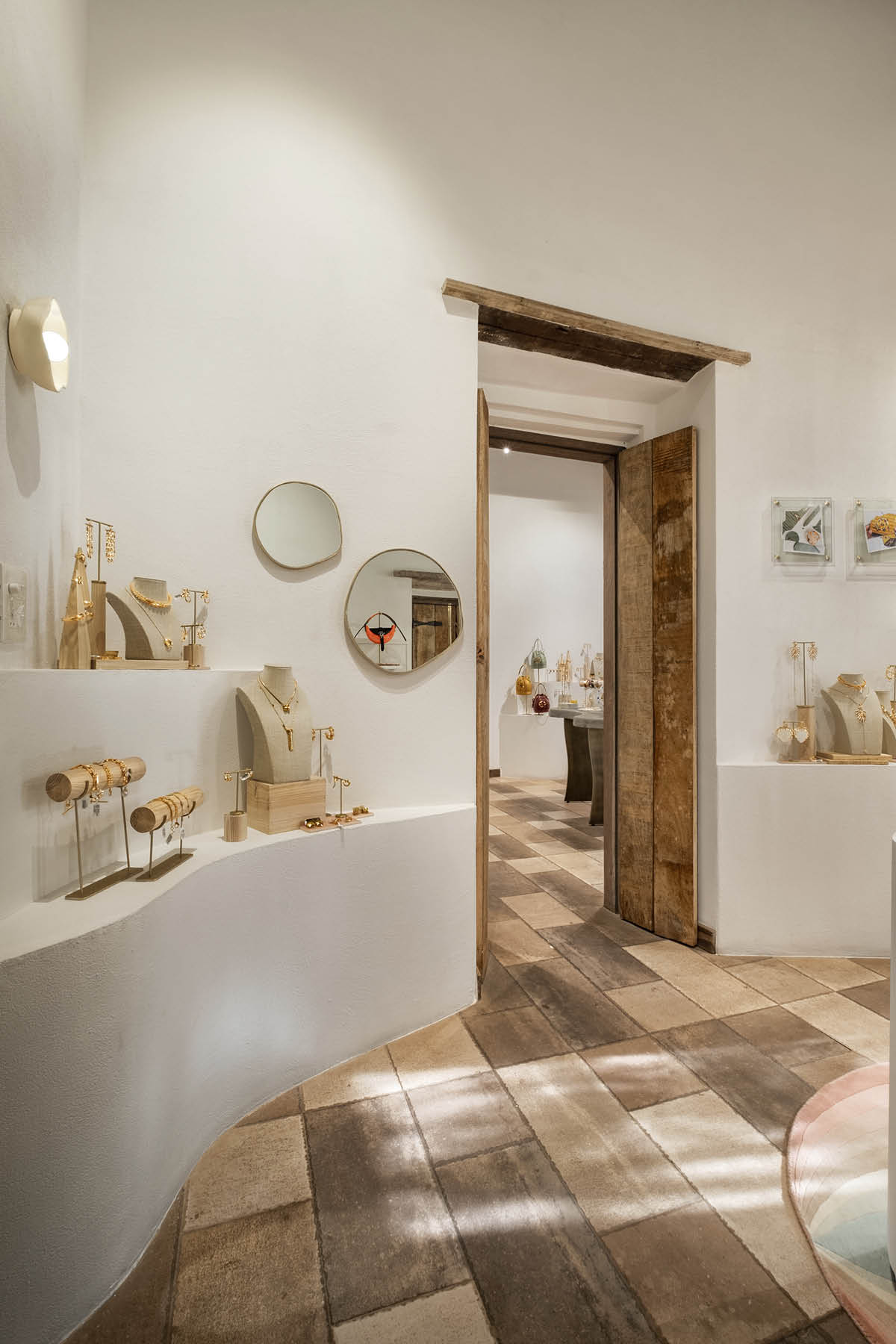 Retail space of Outhouse Jewellery in Goa featuring salmon pink palette and textured material surfaces