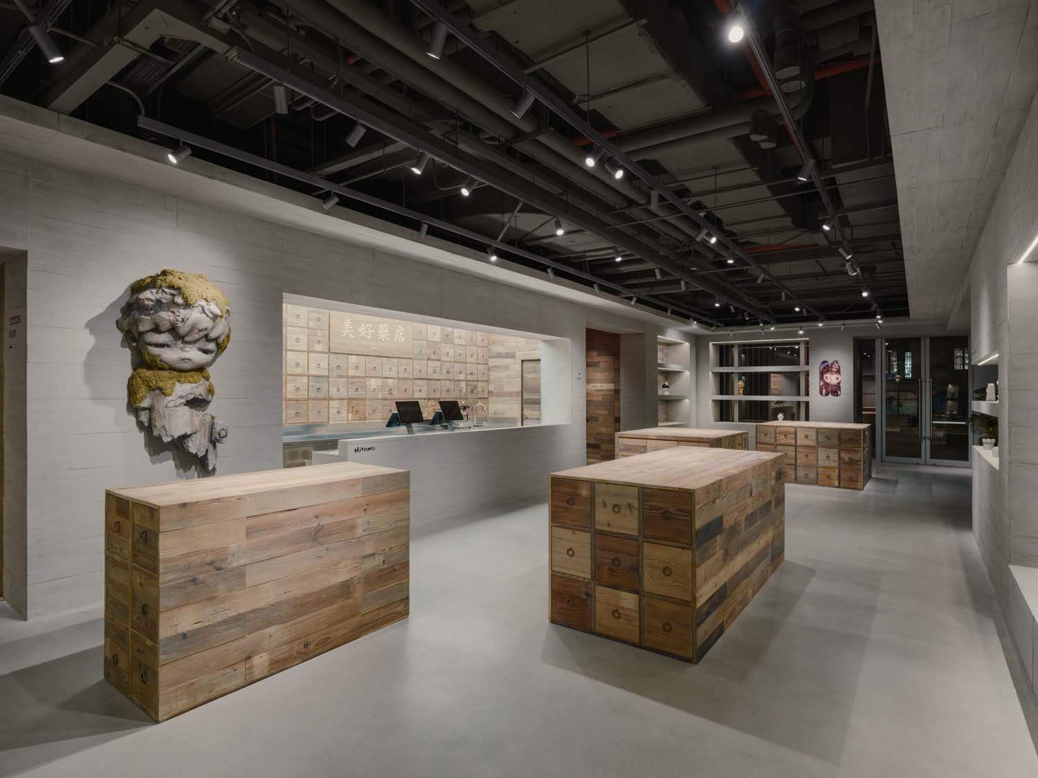 Retail area of the Hirono store in Shanghai with wooden display units, wall shelving and track lighting