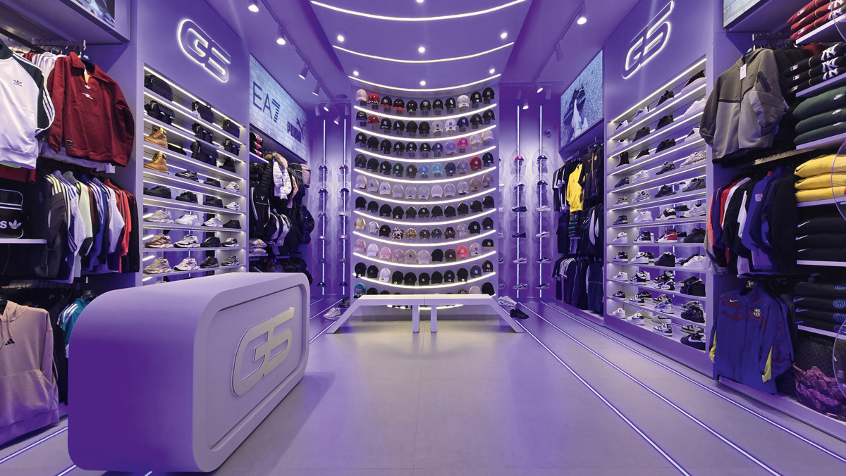 Curved cap display wall with illuminated arch in Galaxy Store Naples