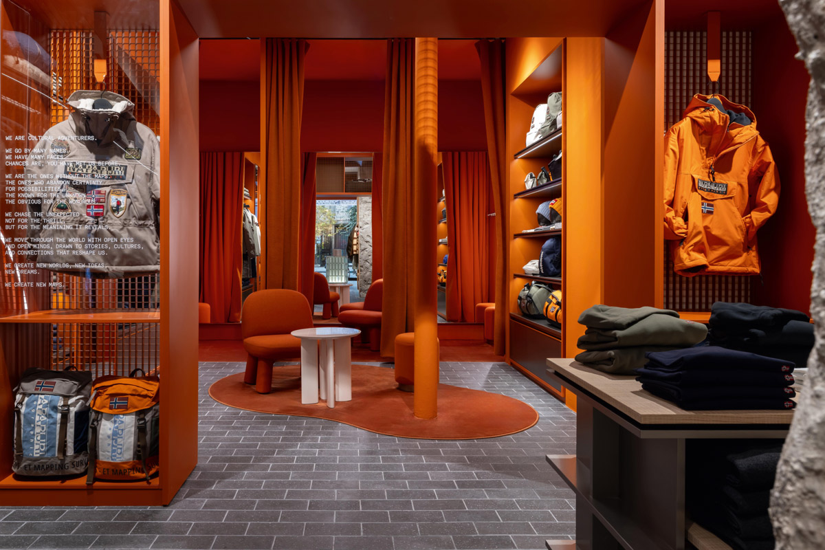 Napapijri retail area with orange interior design, central seating and outdoor apparel display
