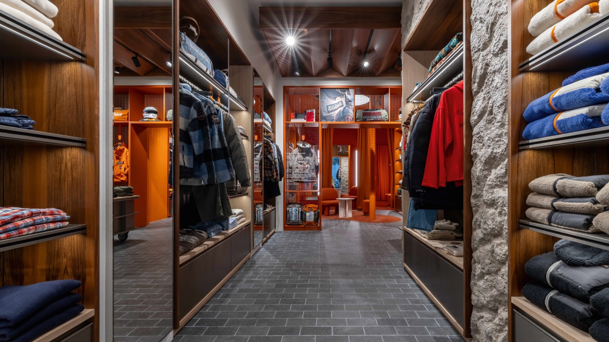 Napapijri display corridor with wooden shelving, textured wall and outdoor apparel display