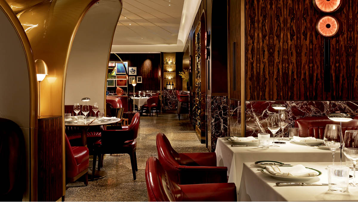 Entrance of Sammarco steakhouse in Toronto with amber glass portal and bar area