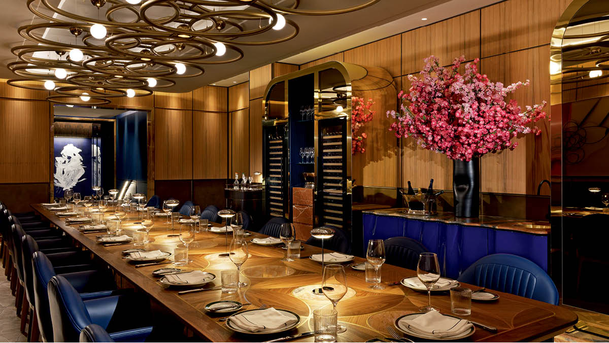 View of the private Carlevale Room with bespoke table and blue leather seating