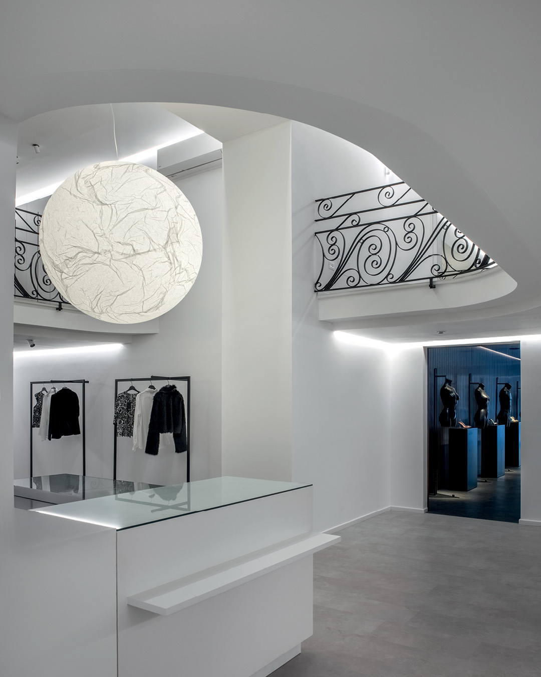 Moon suspension in the double-height space of Le Monde Concept Store in Alcamo with decorative iron railing