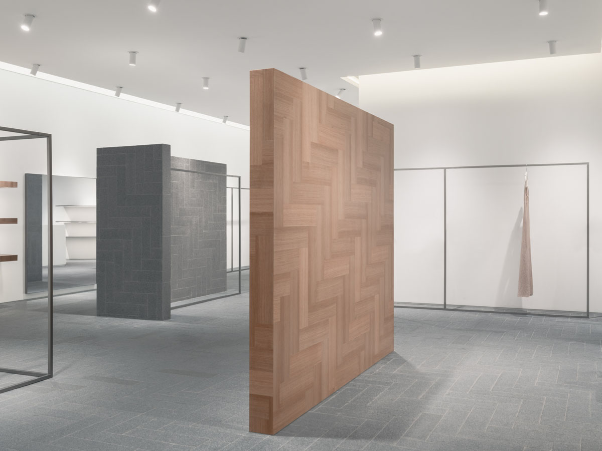 Display area with granite walls and metal structures inside the fashion retail store